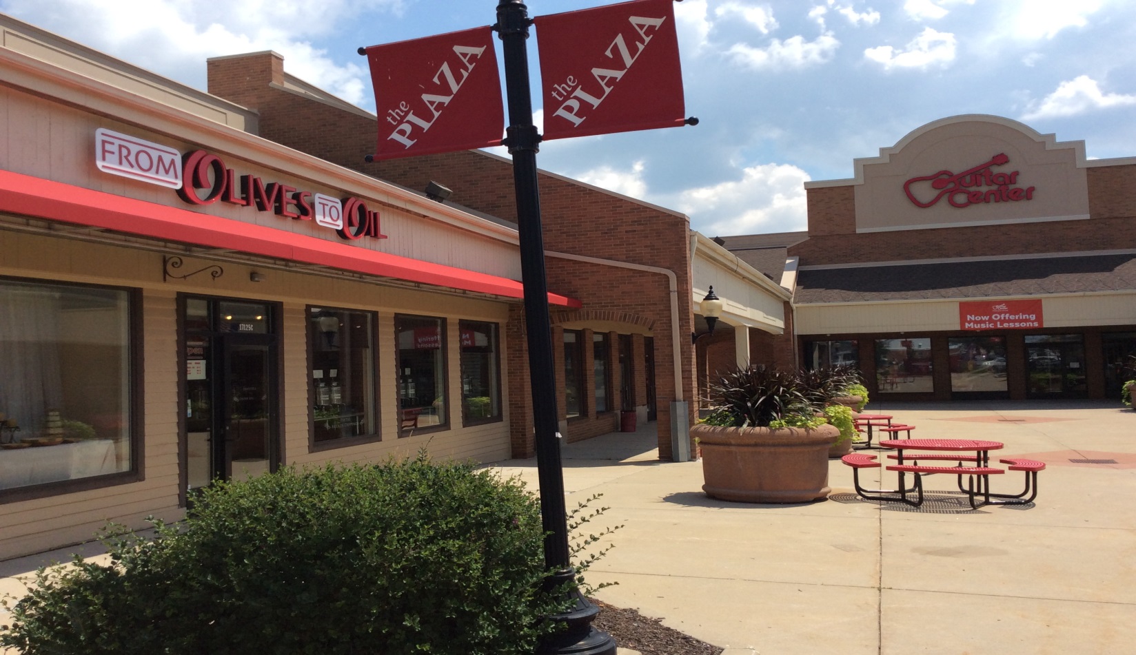 A red sign sitting in front of a store.