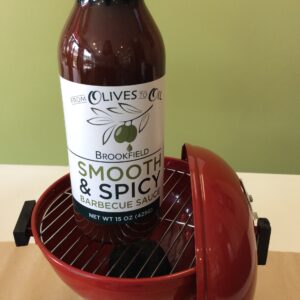 A bottle of beer is sitting in an electric grill.