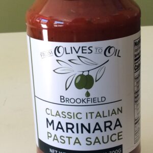 A jar of marinara sauce on top of a table.