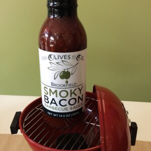 A bottle of bacon sitting on top of a grill.
