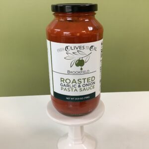 A jar of pasta sauce sitting on top of a white stand.